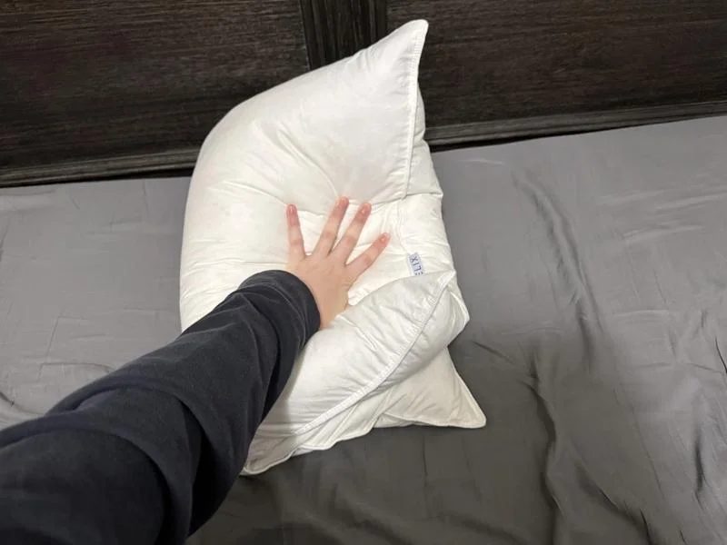 Our tester fold the Helix Down Pillow in half to assess the floofiness.