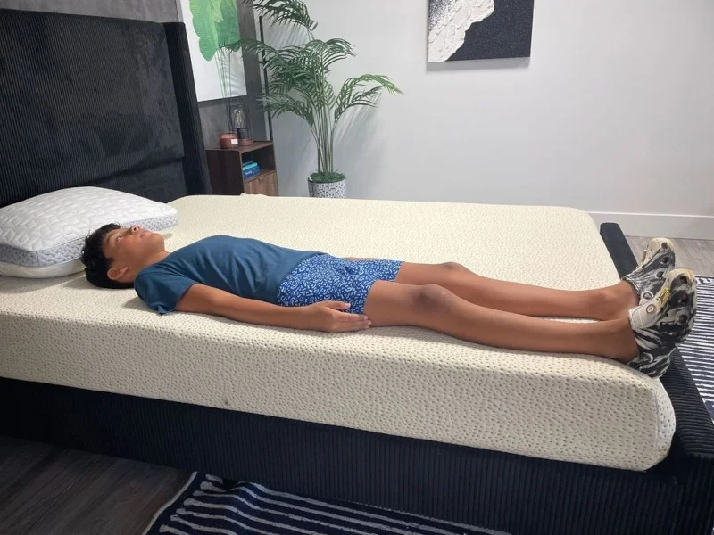 Our tester assesses a back-sleeping position on a 5 Little Monkeys Memory Foam Mattress
