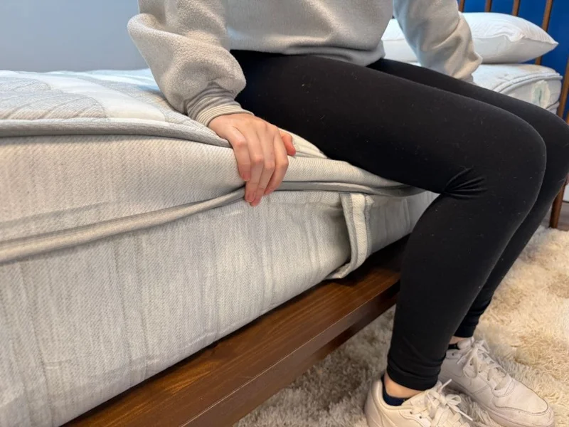 Our tester does a seated edge support test on a Leesa Plus Hybrid Mattress