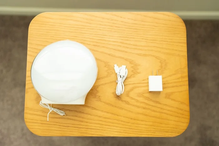 A recently unboxed Jall Sunrise Alarm Clock. The various parts are laid out on a table.