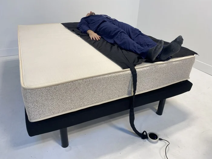 A man lying on his back on the Birch Natural mattress.