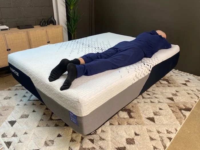 A man lying on his stomach on the Nectar Luxe Memory Foam mattress.