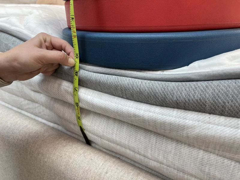 Measuring weight plates on the edge of the Helix Plus Mattress