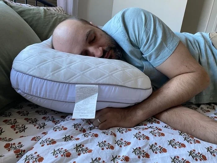 Side view of our expert using the Bear Contour Pillow.