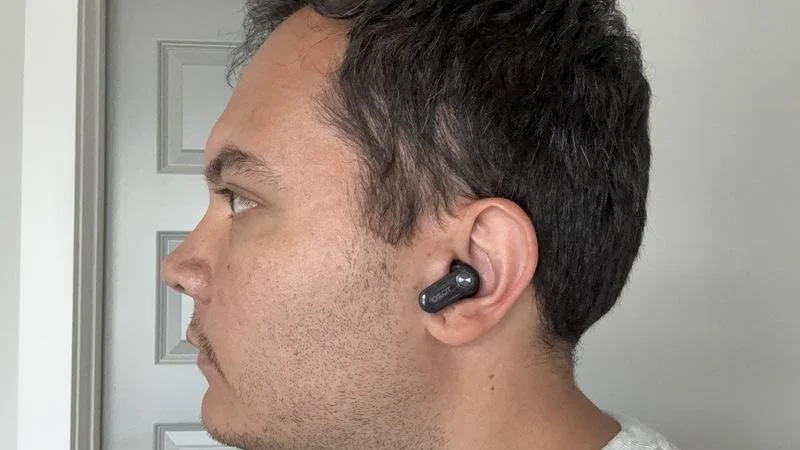 Our product tester poses with a pair of Tozo Crystal Pods