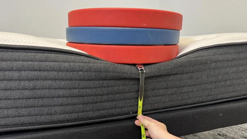 Measuring the deflection of weight plates along the edge of the Plank Firm Mattress