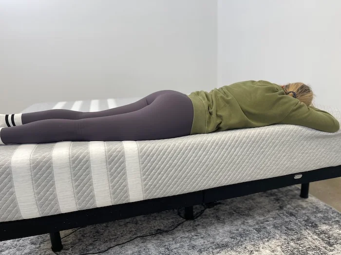 A woman sleeping on her stomach on the Leesa Original mattress.