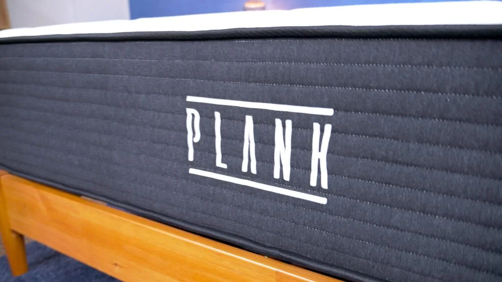 A closeup of the Plank logo on the Plank Firm mattress.