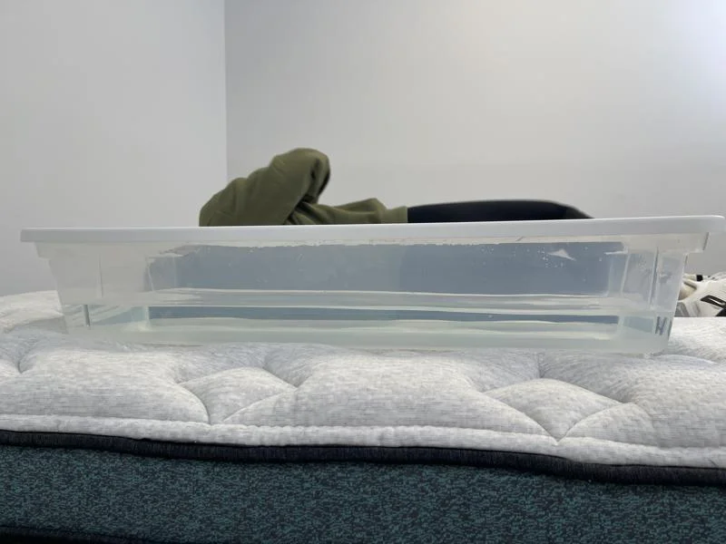 Our tester performs a ripple test on the Helix Sunset Luxe Mattress