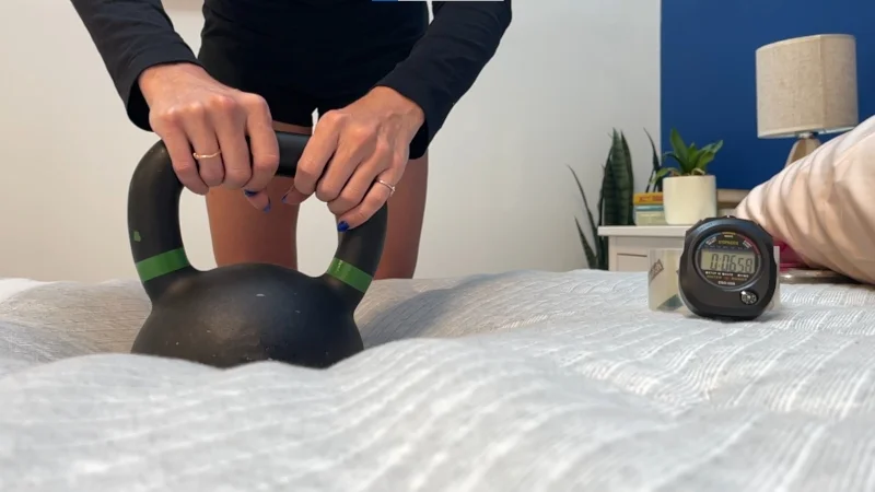 Our tester performs a response test on a Leesa Plus Hybrid mattress