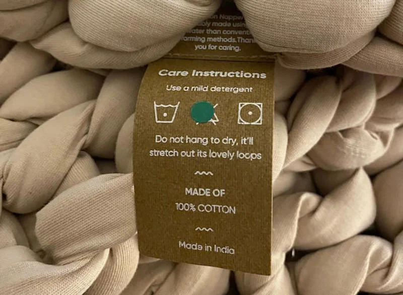 A close look at the care tag for a Bearaby Weighted Blanket