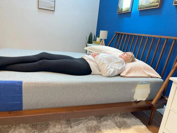 A woman lying on her back on the Casper The One mattress.