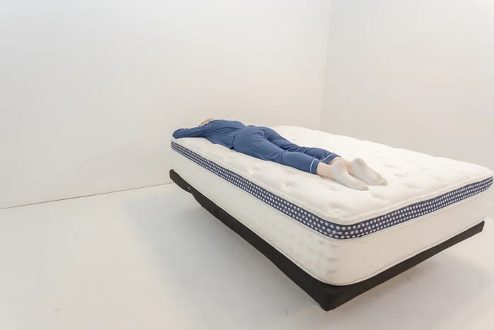 A woman lying on her stomach on the WinkBed.