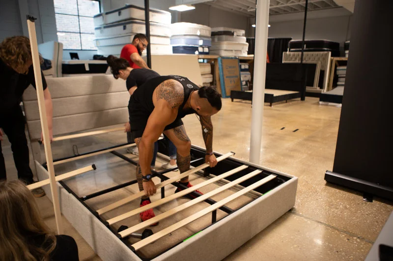 Our tester Stephen assembles an Allewie Storage Bed at the Sleepopolis studio.