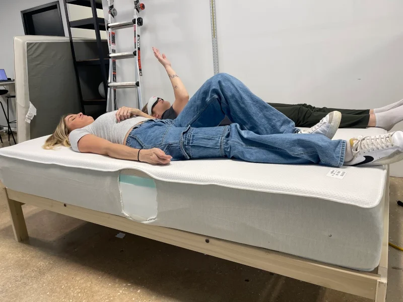 Our testers performing a partner test to evaluate the motion isolation properties of a Boring Hybrid Mattress.