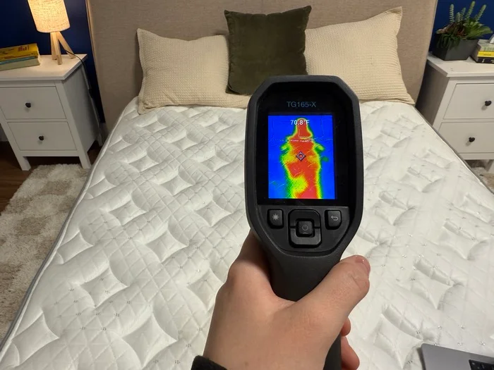 A thermal gun aimed at the surface of the Helix Moonlight showing the thermal outline of a sleeper