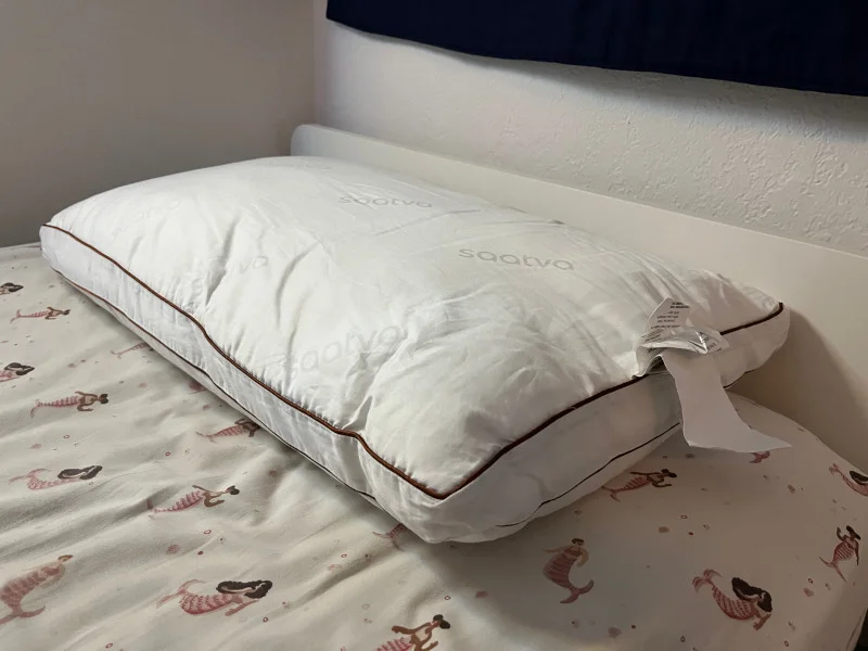 The Saatva Latex Pillow on a bed at the Sleepopolis studio