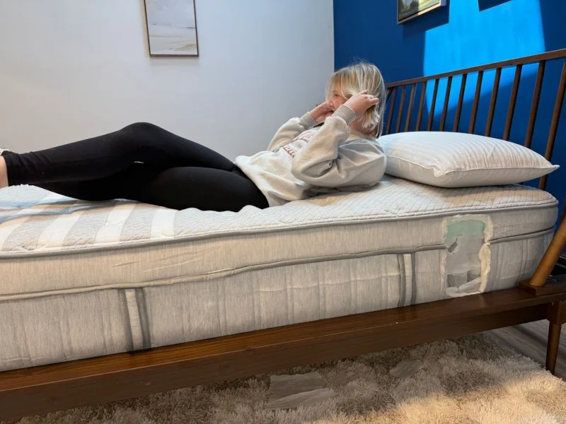 Our tester rolling around on a Leesa Plus Hybrid Mattress
