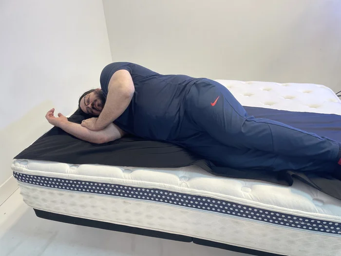 A man lying on the WinkBed on his side.