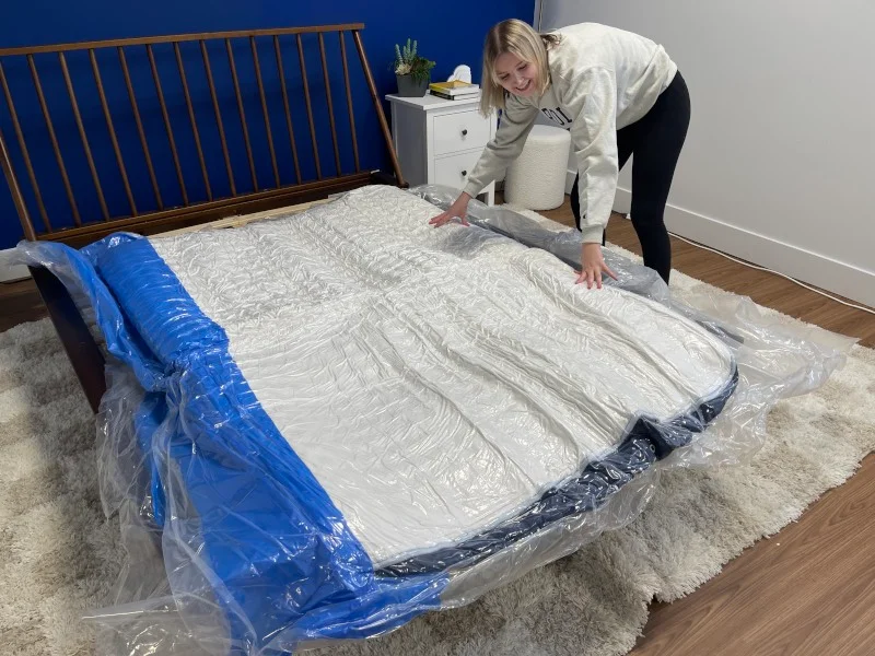 Our tester unboxing a Glacier Original Hybrid Mattress