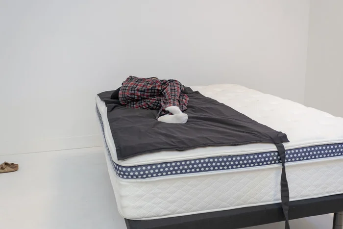 A woman lying on her side on the WinkBed.