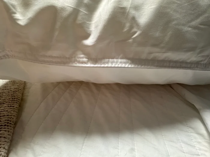 A closeup of the hem of the Peacock Alley Down Alternative Pillow.