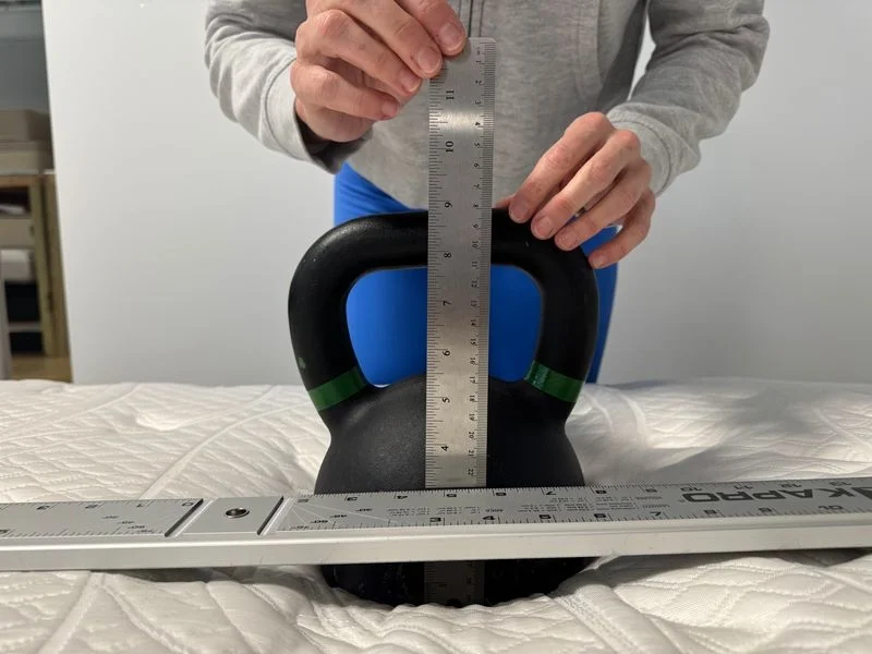 Our tester performs a sinkage test on the Glacier Original Hybrid Mattress