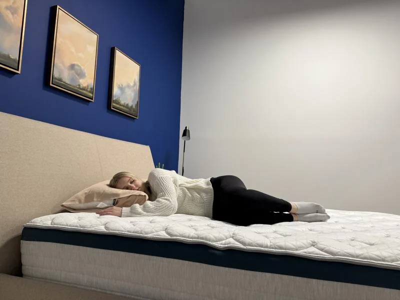 Our tester side-sleeping on the Helix Twilight Mattress