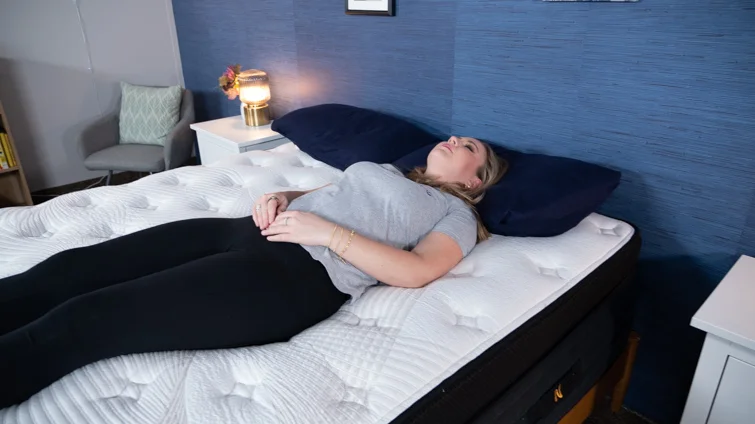 A woman back sleeping on the Nolah Evolution mattress.