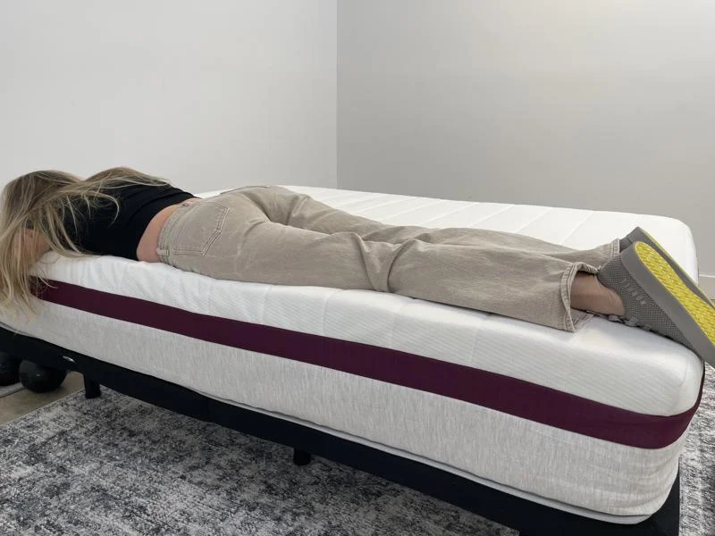 Our tester stomach-sleeping full body edge support test of the Helix Dusk Mattress