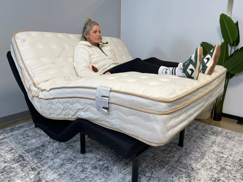 Our product tester checks the fitment of the Saatva Classic Luxury Firm on an adjustable bed frame.