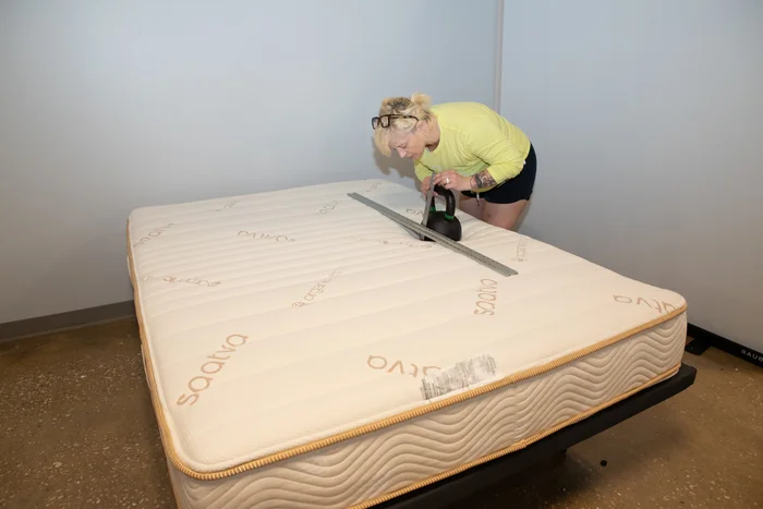 Performing our sinkage test on the surface of the Zenhaven mattress