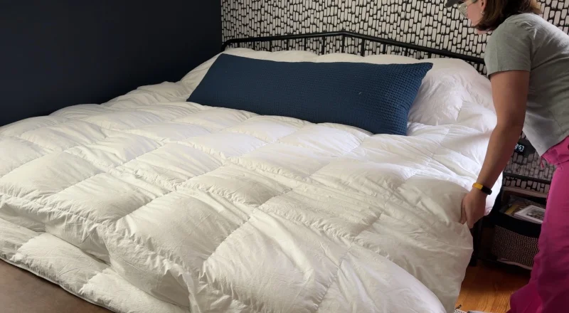 Our tester tucking in a Brooklinen Down Alternative Comforter