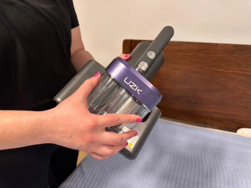 A close look as someone opens a UZK vacuum cleaner.