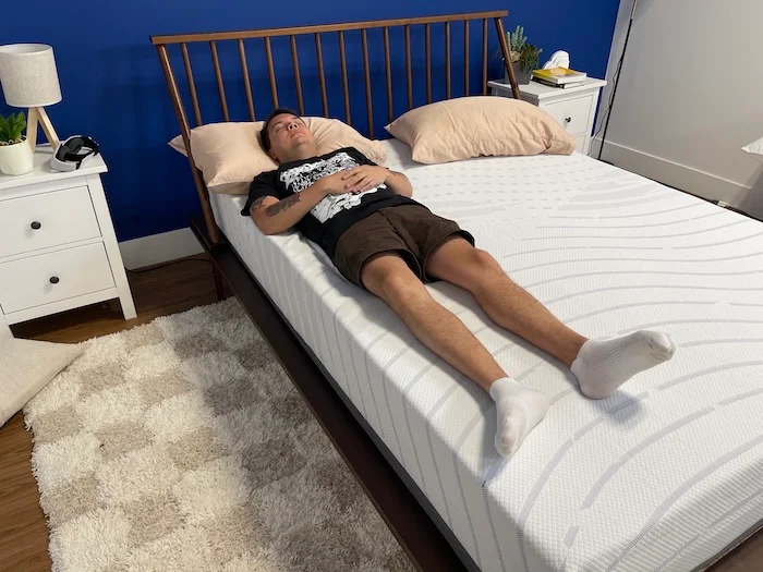 A man back sleeping on the BodiPedic 12" mattress.