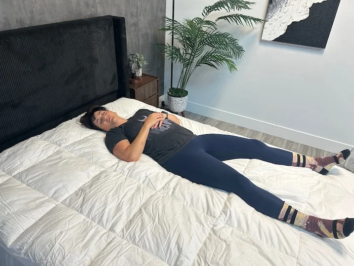 Our tester Kate blissing out on a Peacock Alley Down Alternative Mattress Topper