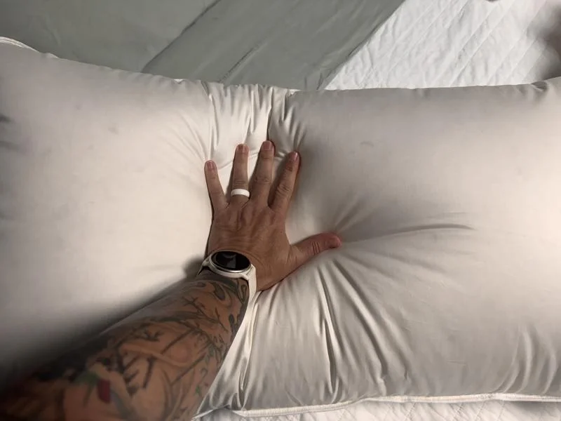 Our tester getting a feel for the Quince Luxe Goose Down Pillow