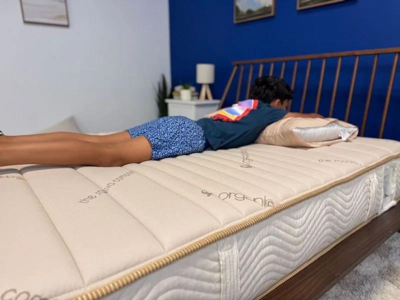 Our tester stomach-sleeping on a Saatva Youth Mattress