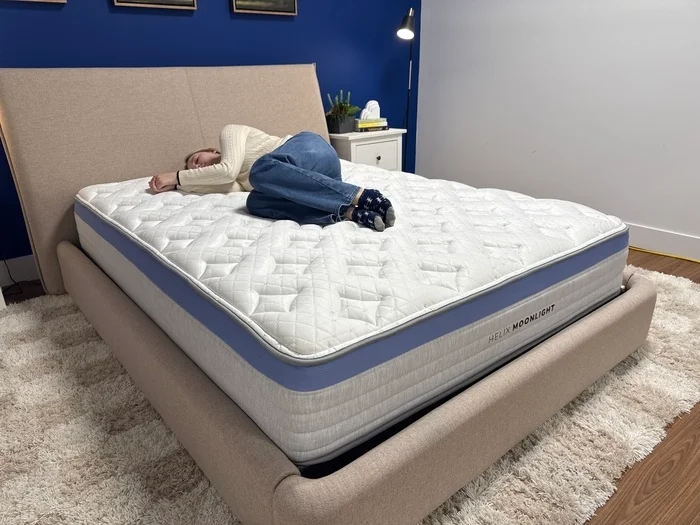 A young woman lies on her side on the Helix Moonlight