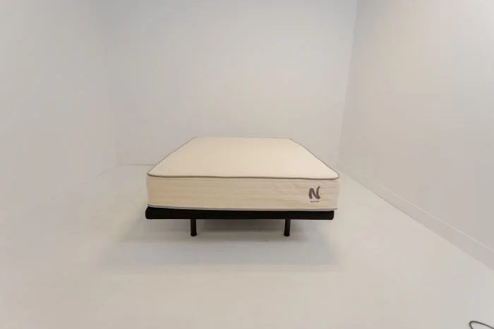 The Nolah Natural mattress sitting in a white room.