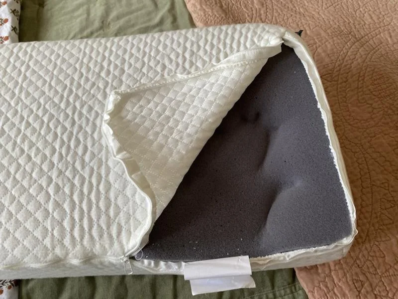 A hand impression is shown on the foam inside a Pillow Cube Side Cube.