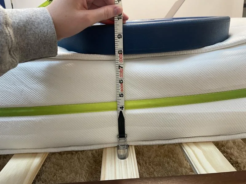 Measuring weight plates on the edge of the Helix Kids 8-Inch Mattress