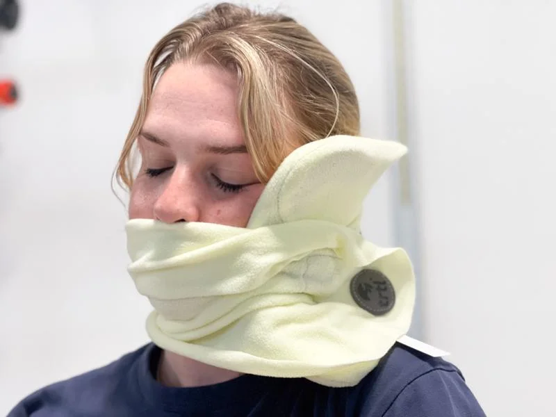 Our tester using the trtl Travel Pillow