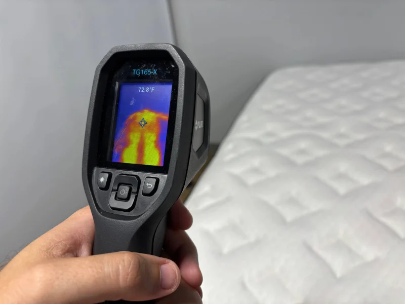 Using a thermal gun to measure the surface temperature of the Nolah Evolution Comfort Plus.