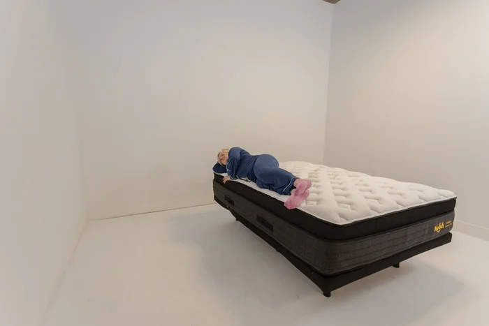 A woman lying on the Nolah Evolution mattress in the side-sleeping position.
