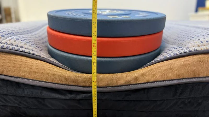 Our tester measures the deflection of weight plates along the edge of the Brooklyn Bedding CopperFlex Mattress